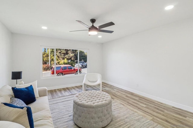 sitting room featuring ceiling fan and hardwood / wood-style floors