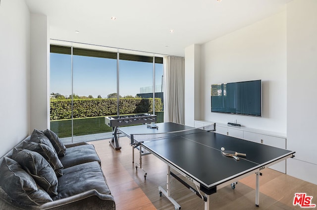 game room with hardwood / wood-style floors and floor to ceiling windows