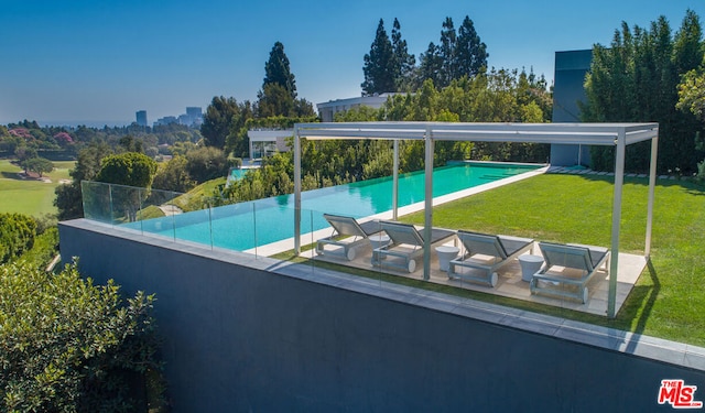 view of swimming pool with a lawn and a patio