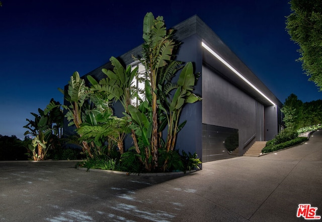 property exterior at night with a garage