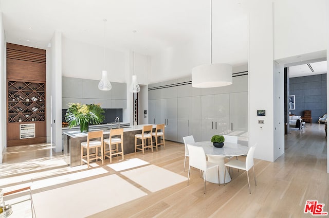 dining room with sink and light hardwood / wood-style floors