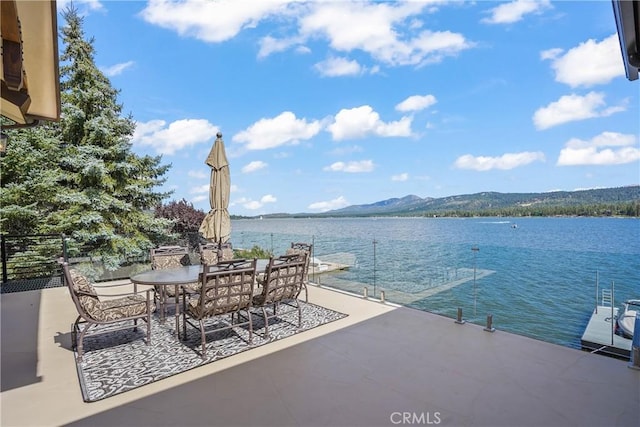 view of patio featuring a water and mountain view