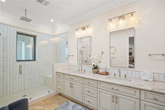 bathroom with a shower with door, vanity, and ornamental molding