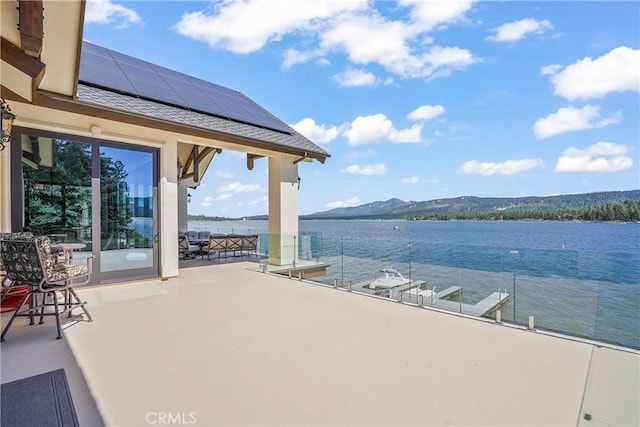 view of patio featuring a water and mountain view