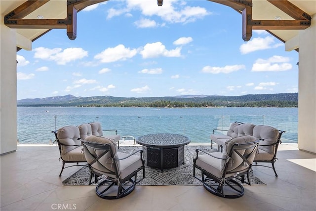 view of patio / terrace featuring a water and mountain view