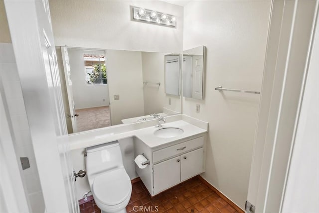 bathroom with toilet and vanity