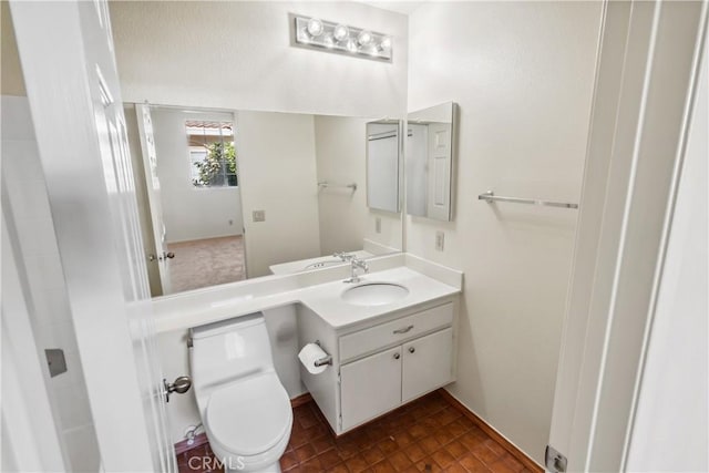 bathroom featuring toilet and vanity