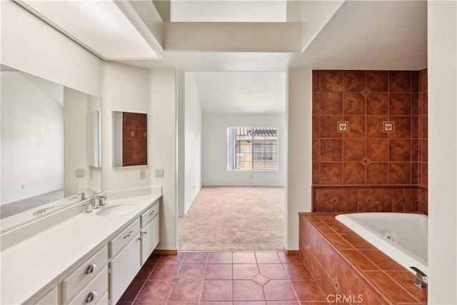 bathroom featuring tiled bath, tile patterned floors, and vanity