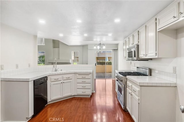 kitchen featuring appliances with stainless steel finishes, white cabinets, and dark wood-type flooring