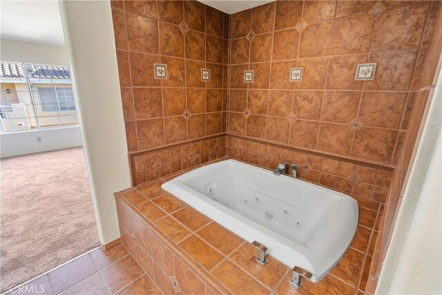 bathroom with tile patterned floors and tiled tub