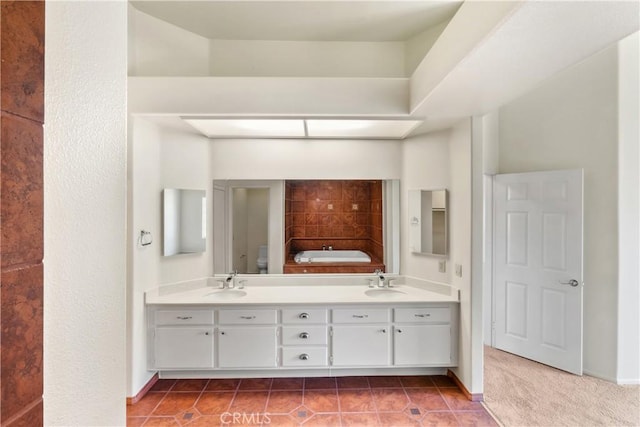 bathroom with tile patterned floors, a sink, and double vanity