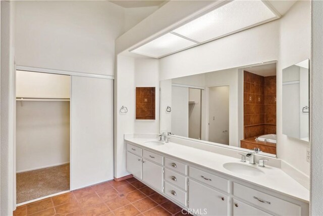 bathroom featuring tile patterned floors, vanity, and a bathing tub