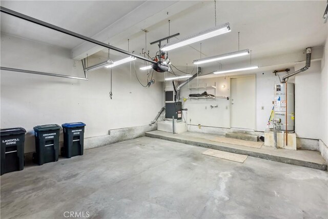 garage with water heater and a garage door opener