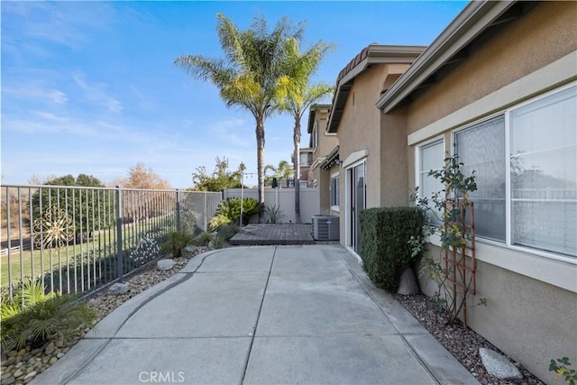 view of side of home featuring a patio area and central AC unit