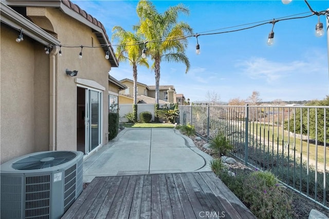 wooden deck with cooling unit and a patio area