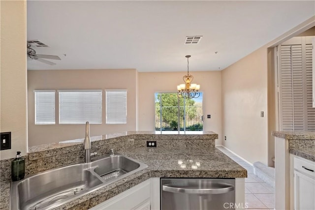 kitchen with dishwasher, light tile patterned floors, white cabinetry, ceiling fan with notable chandelier, and sink