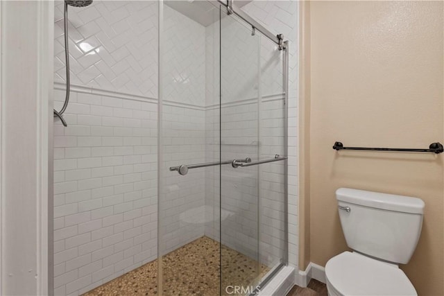 bathroom featuring toilet and walk in shower