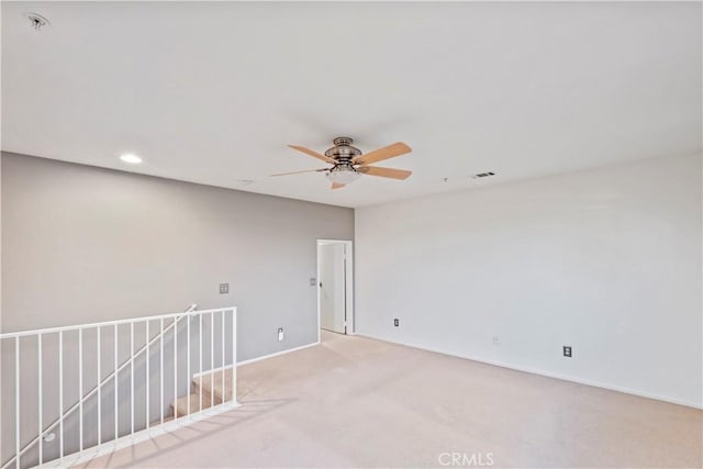 unfurnished room with carpet floors and ceiling fan