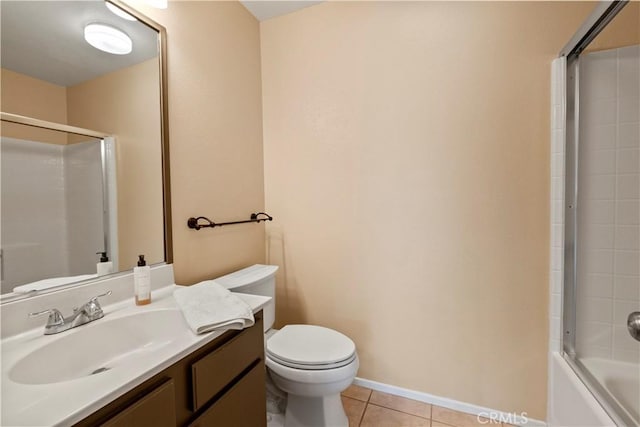 full bathroom with vanity, bath / shower combo with glass door, tile patterned floors, and toilet