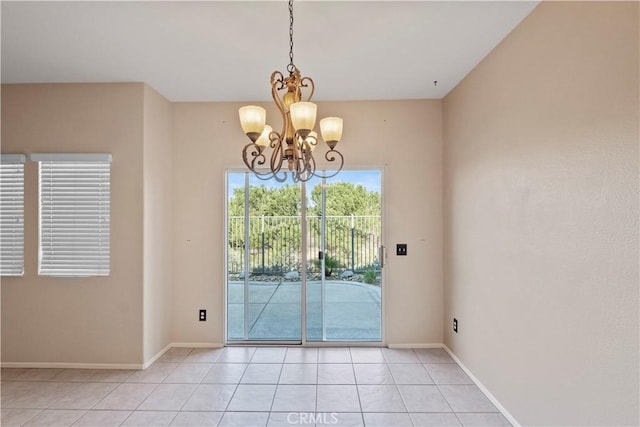 entryway featuring a chandelier and light tile patterned floors