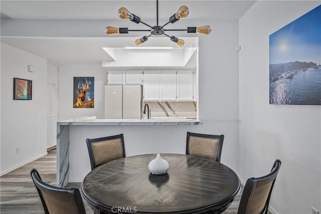 dining area with sink and hardwood / wood-style floors