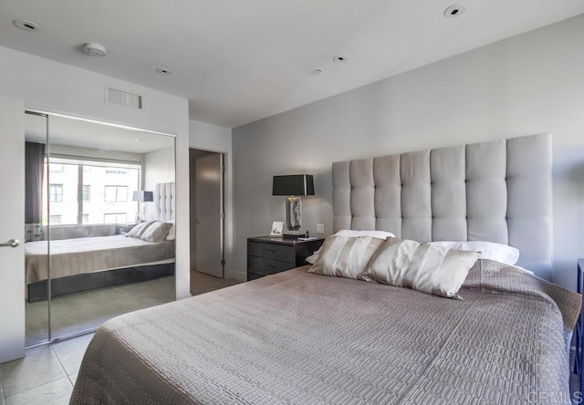 bedroom featuring light tile patterned flooring and a closet