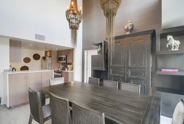 tiled dining room featuring a towering ceiling