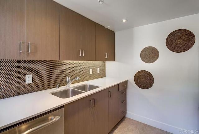 kitchen with sink, backsplash, dishwasher, and light tile patterned floors