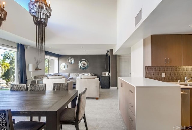 dining space featuring sink and a notable chandelier