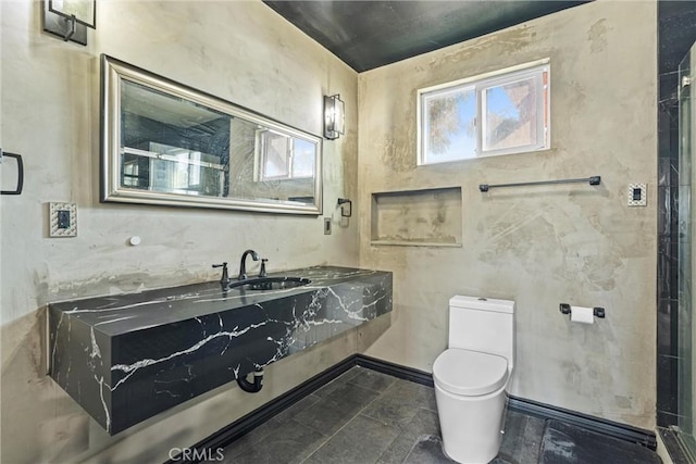 bathroom featuring toilet and sink