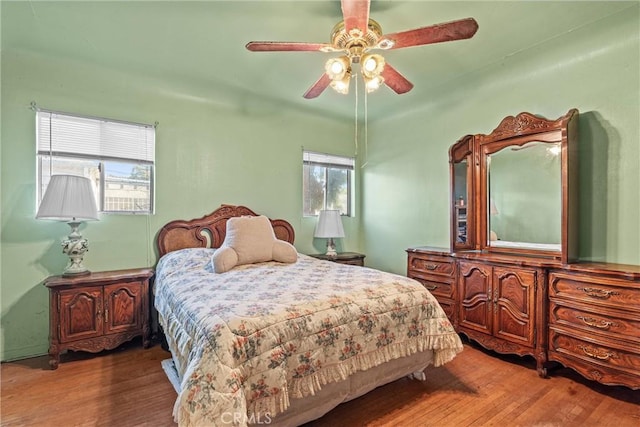 bedroom with ceiling fan and hardwood / wood-style floors