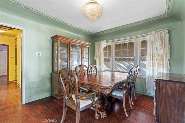 dining space featuring a notable chandelier and dark hardwood / wood-style flooring