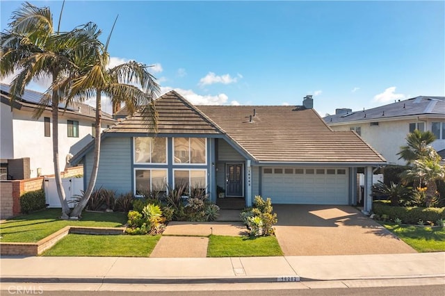 front facade featuring a garage and a front yard