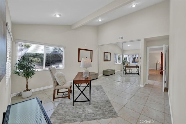 dining space featuring light tile patterned flooring and vaulted ceiling with beams