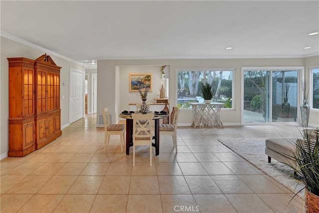 tiled dining area featuring crown molding