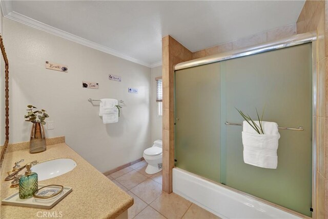 full bathroom featuring crown molding, combined bath / shower with glass door, vanity, tile patterned floors, and toilet