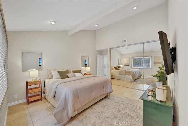 bedroom with lofted ceiling with beams and light tile patterned flooring