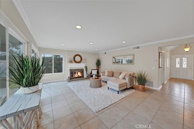 living room with light tile patterned floors and crown molding