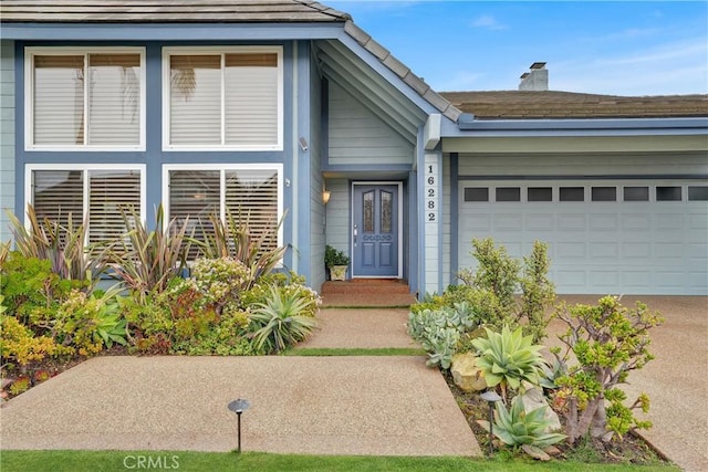 view of exterior entry featuring a garage