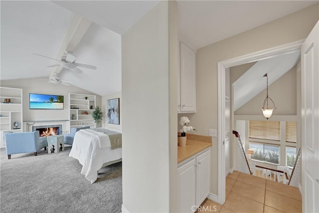 bedroom with vaulted ceiling with beams, light colored carpet, and ceiling fan