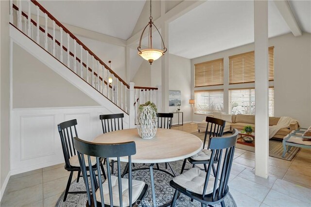 dining room featuring lofted ceiling and light tile patterned floors