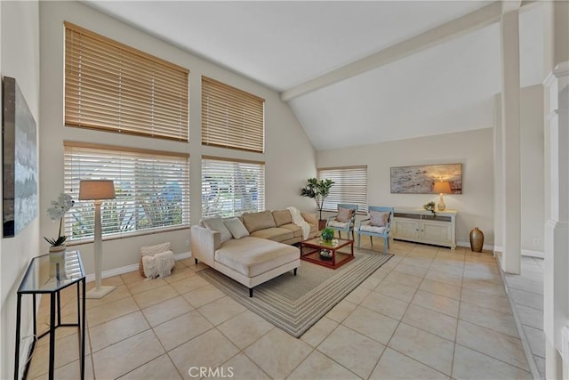 tiled living room featuring decorative columns and high vaulted ceiling