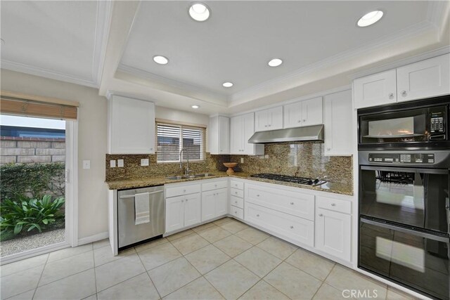 kitchen featuring sink, white cabinetry, dark stone countertops, a tray ceiling, and black appliances