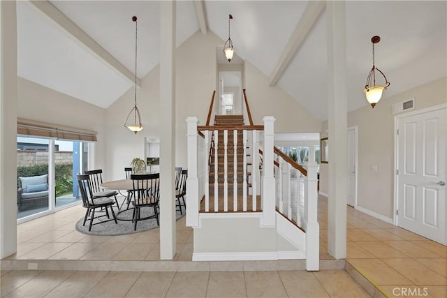 stairs featuring beamed ceiling, tile patterned floors, and high vaulted ceiling