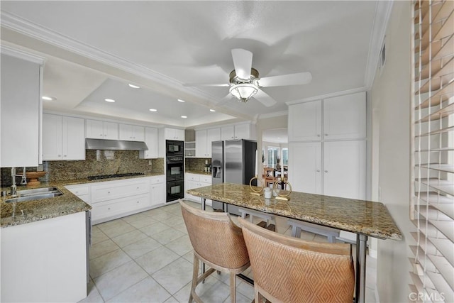 kitchen featuring sink, black appliances, white cabinets, and stone countertops