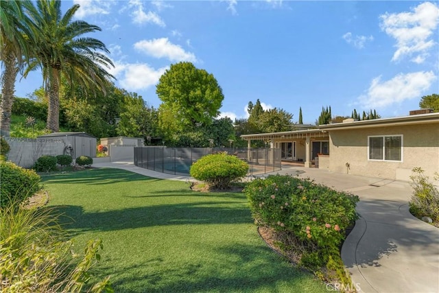 view of yard with a storage unit and a patio