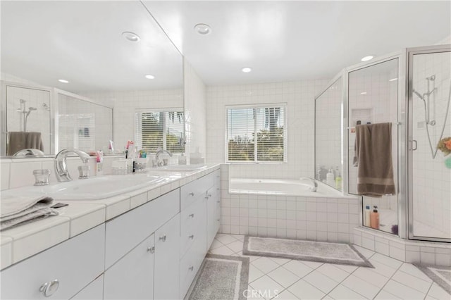 bathroom featuring vanity, independent shower and bath, and tile patterned floors