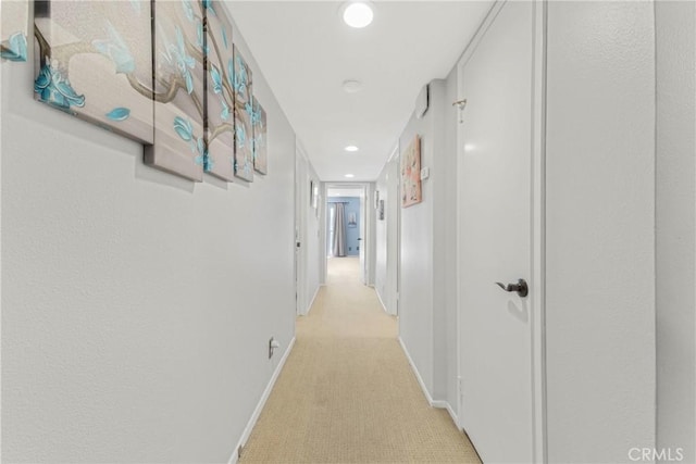 corridor with light colored carpet