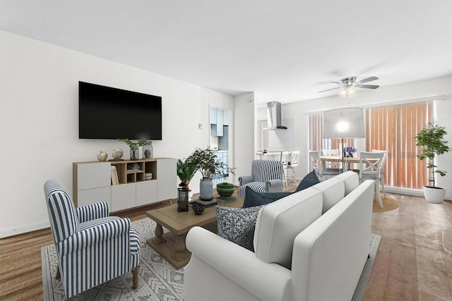 living room featuring ceiling fan and light hardwood / wood-style floors