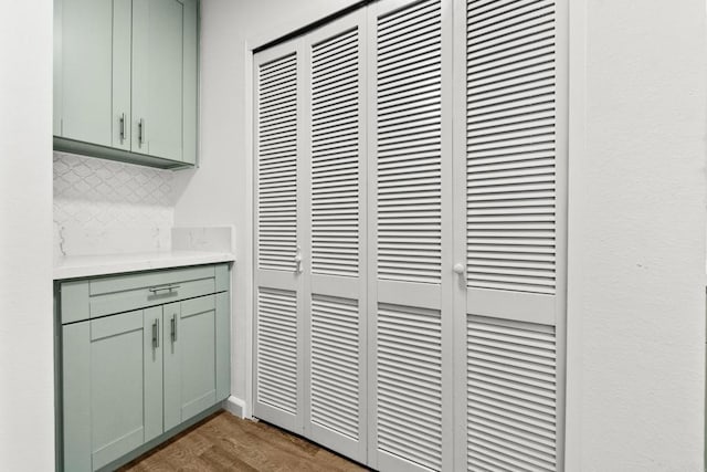 interior details with hardwood / wood-style floors and backsplash